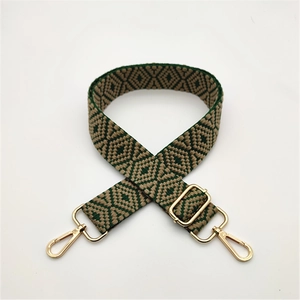 Ethnic style woven shoulder strap with green geometric patterns and gold metal hooks