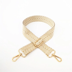 Close-up of woven herringbone shoulder strap with adjustable golden metal buckles