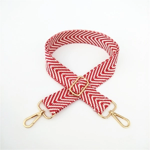 Detail of adjustable red and white woven chevron strap with golden lobster clasps