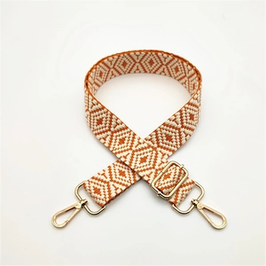 Adjustable woven shoulder strap for handbags with orange and white geometric diamond patterns