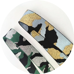 Close-up of camouflage elastic shoulder straps with metallic glitter weave and sturdy texture