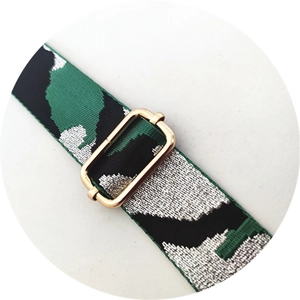 Detail of green camouflage woven strap with a polished golden metal adjustment buckle
