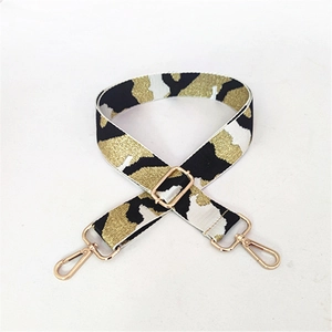 Detail of adjustable camo shoulder strap with gold glitter weaving and swivel metal hooks