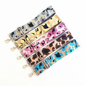 Detail showing five leopard print bag straps with adjustable golden metal hardware clasps