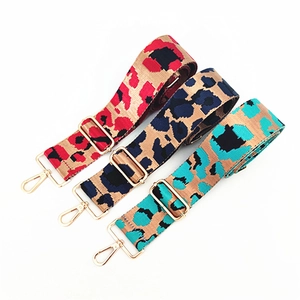 Detailed view of woven leopard print bag straps in three colors with gold buckles