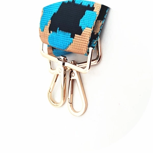 Close-up of leopard pattern nylon shoulder strap with light gold lobster clasps