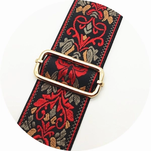 Close-up of ethnic jacquard woven strap with golden adjustable metal buckle detail
