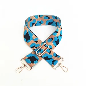 Detail of blue leopard print wide adjustable shoulder strap with gold metal hooks