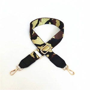 Detail of adjustable camouflage bag strap with gold glitter weaving and metal lobster clasps