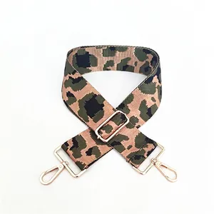 Detail view of adjustable leopard print bag strap with golden metal lobster clasps