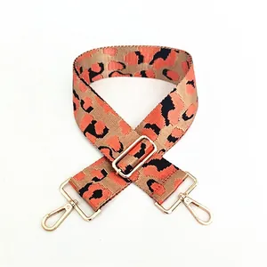 Close-up of leopard print crossbody bag strap with adjustable gold metal hardware