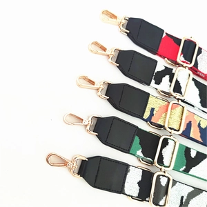 Adjustable wide camouflage woven strap for bags with leather ends and gold metal clips
