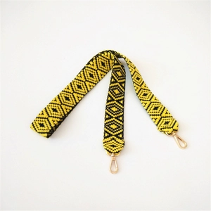 Adjustable yellow and black geometric jacquard woven shoulder strap with gold metal buckles