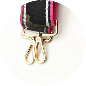 Detailed macro shot of durable woven camouflage strap with polished gold lobster clasps