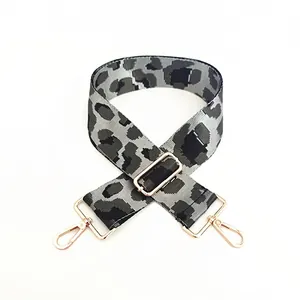 Detail of adjustable leopard print bag strap with golden rotating metal hooks
