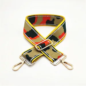Close-up of adjustable camo shoulder strap with gold metal hooks and colorful weaving