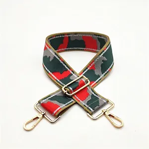 Macro view of thickened red and green camouflage shoulder strap with gold metal buckles