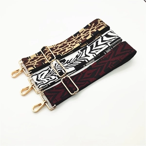 Close-up of leopard, zebra, and ethnic patterns on adjustable wide woven bag straps