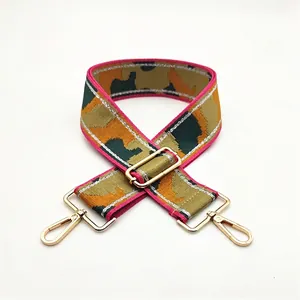 Detail view of camouflaged wide bag strap Style 5 with pink edges and gold metal hooks