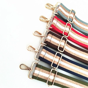 Détail de bandoulières réglables tissées avec fil doré et boucles métalliques dorées
