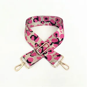 Detail view of wide leopard print pink and grey adjustable shoulder strap with gold hooks