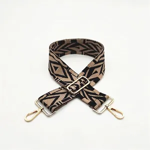 Detailed view of ethnic style jacquard bag strap with golden metal hooks and buckle