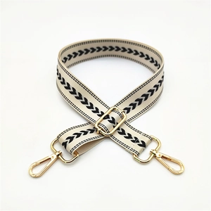 Adjustable woven shoulder strap with black chevron patterns and golden metal hooks