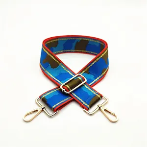 Adjustable camouflage bag strap with blue and brown patterns and gold metal hooks