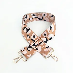 Close-up of adjustable leopard print bag strap with high-quality gold metal hooks