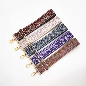 Five adjustable ethnic paisley pattern purse straps with gold hooks on white background