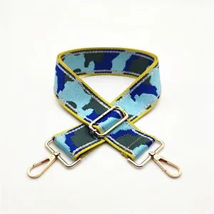 Adjustable camouflage canvas bag strap with golden metal hooks and blue green pattern