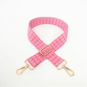 Adjustable pink and white houndstooth pattern bag strap with gold metal buckles