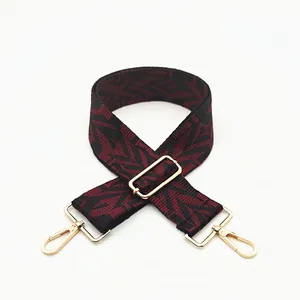 Adjustable wide replacement bag strap with black and red geometric pattern and gold hardware