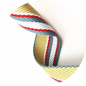 Detail of multi-color striped woven strap with gray, red, and gold twill pattern texture