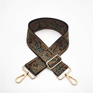 Close-up of adjustable ethnic paisley strap with premium golden metal swivel hooks