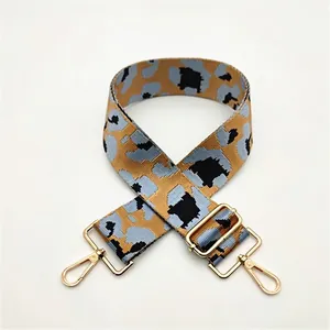 Close-up of leopard print wide replacement strap with gold metal hooks for handbags