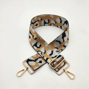 Detail of leopard print crossbody strap with premium gold metal swivel hooks and buckles