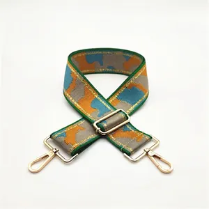 Adjustable wide camouflage woven strap with blue and orange geometric blocks and gold hooks