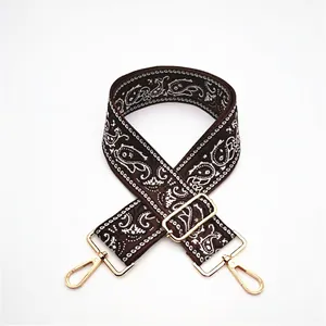 Detail of coffee brown ethnic paisley strap with adjustable gold metal hardware