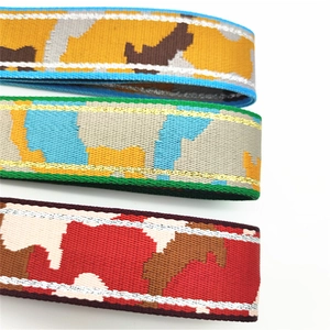 Macro detail of wide camouflage woven straps with metallic glitter thread edges