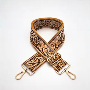 Adjustable brown paisley pattern wide bag strap with gold metal swivel hooks