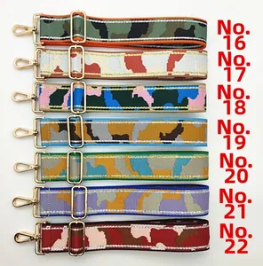 Detail of adjustable wide canvas shoulder straps with camo patterns and gold metal clasps