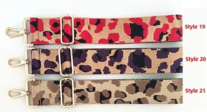Three leopard print bag straps in red, purple, and brown with gold metal hooks