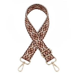 Detail of adjustable woven strap with geometric diamond patterns and gold metal clasps