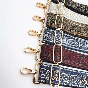 Detail of colorful Paisley patterned shoulder straps with gold metal hooks and buckles
