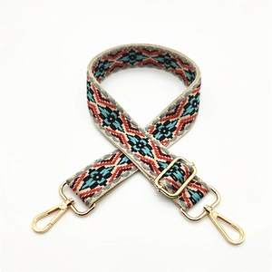 Close-up of ethnic geometric jacquard weaving on adjustable beige cotton bag strap