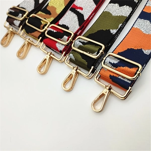 Close-up of adjustable wide camouflage straps for handbags with gold metal lobster clasps