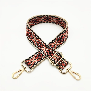Detail of adjustable ethnic geometric woven strap with gold metal lobster clasps