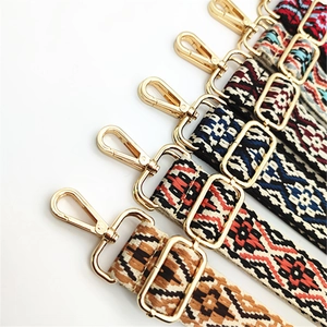 Close-up of five colorful ethnic jacquard woven bag straps with gold metal hardware