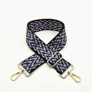 Adjustable wide woven shoulder strap with colorful geometric pattern and gold hardware